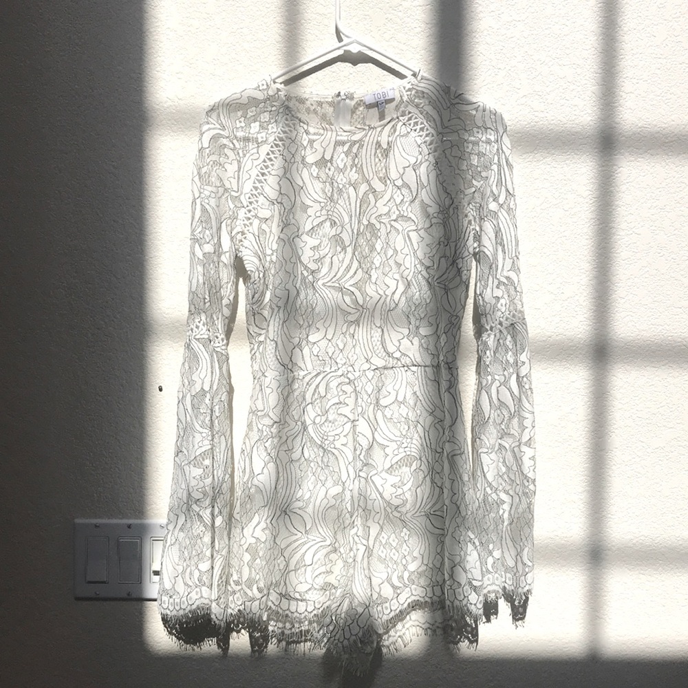 Tobi white lace long sleeved romper.